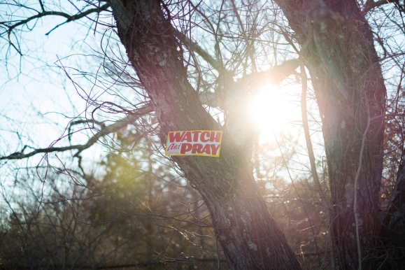 A Watch and Pray sign is nailed to a tree in Ridge, New York. © Joseph Amandola III